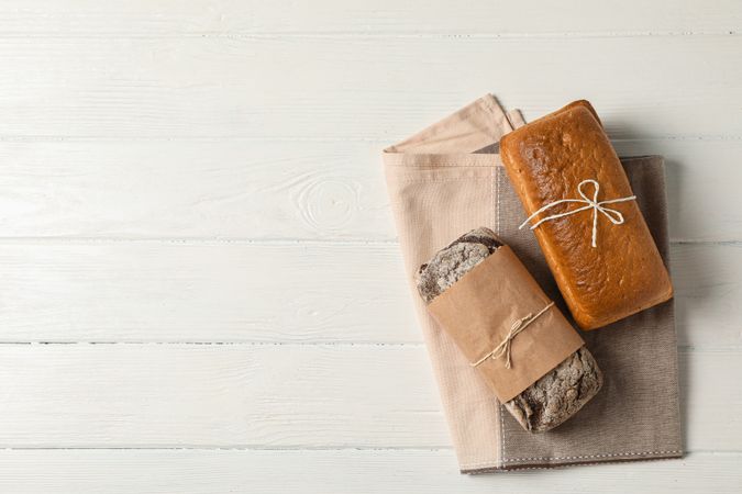 Flat lay composition with bakery products on wooden background, top view and space for text