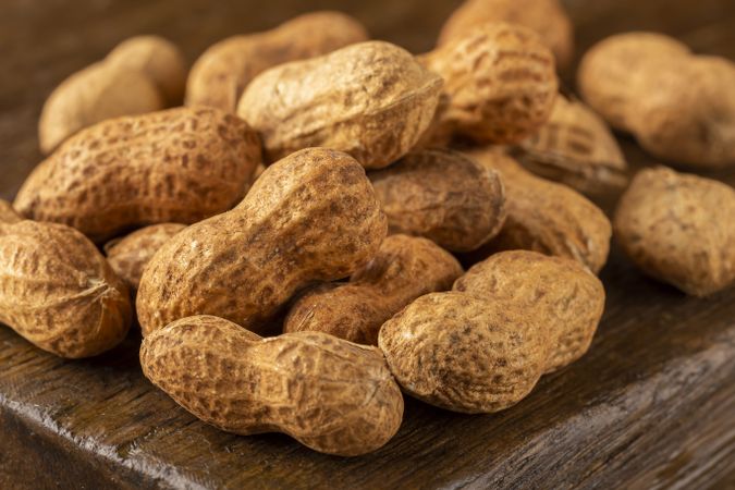 Dry peanut on the wooden background.