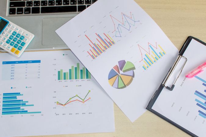 Business Analysis Documents with Graphs and Charts on Desk