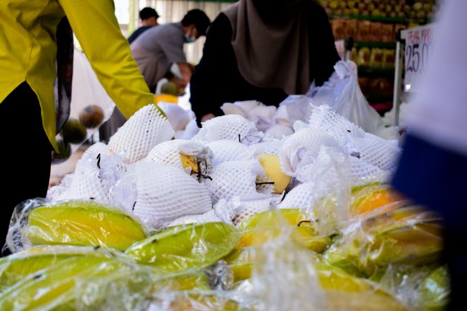 Star fruits wrapped and for sale in market