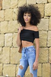 Female posing in front of outside wall