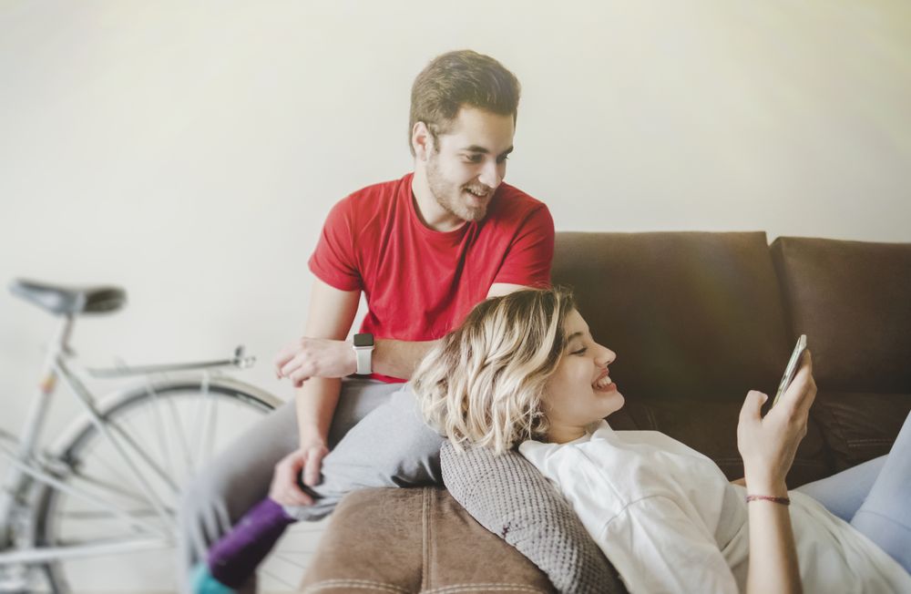 Couple on sofa on the mobile phone