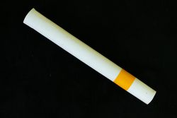 Cigarette laying diagnolly on dark background