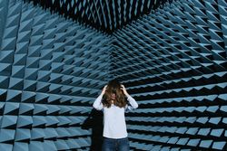 Woman in middle of sound room shaking head