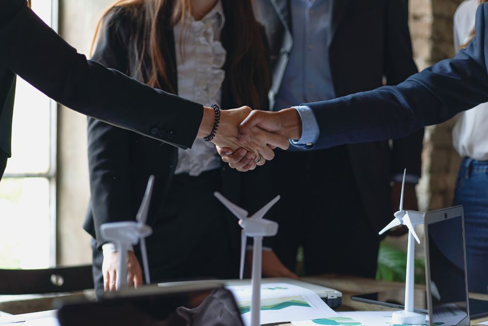 Close-up of a hand shake between a man and a woman in a business setting
