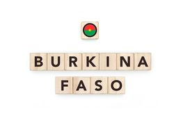 Wooden blocks bearing the name and flag of Burkina Faso. Burkinabe and African Culture, national identity, travel, and geography in a copy space design.