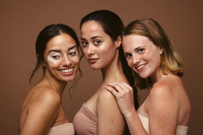Young women with different skin problems standing together