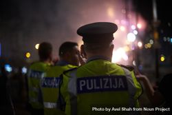 Back of Maltese policemen walking at night 0KwGz0