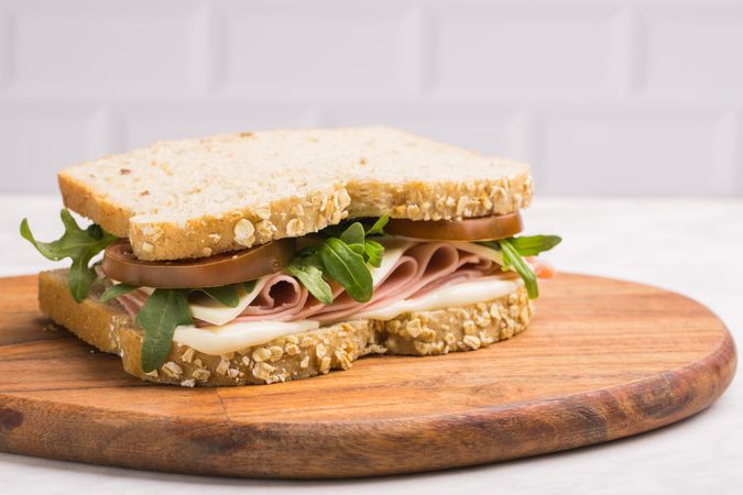 Delicious sandwich with ham, cheese, lettuce and tomato