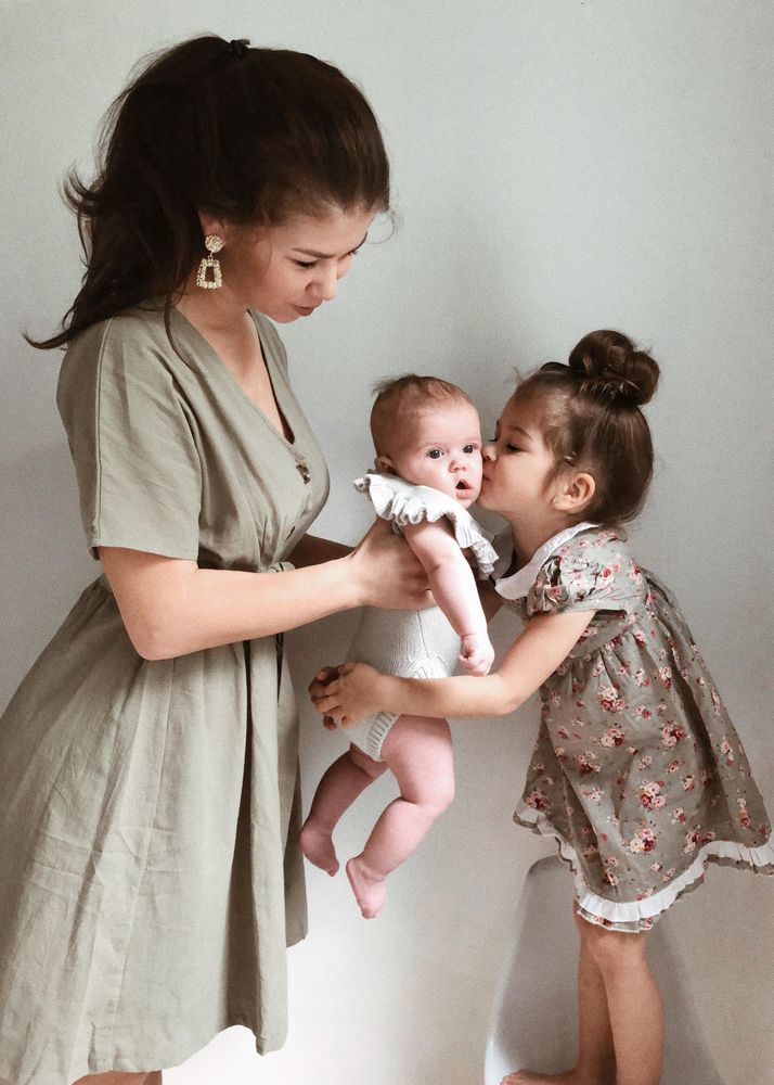 Mother and daughter holding a baby