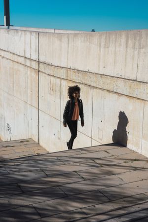 Black woman walking down the street.