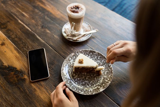 Woman eating cake in restaurant