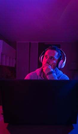 Man listening cheerfully to music with headphones.