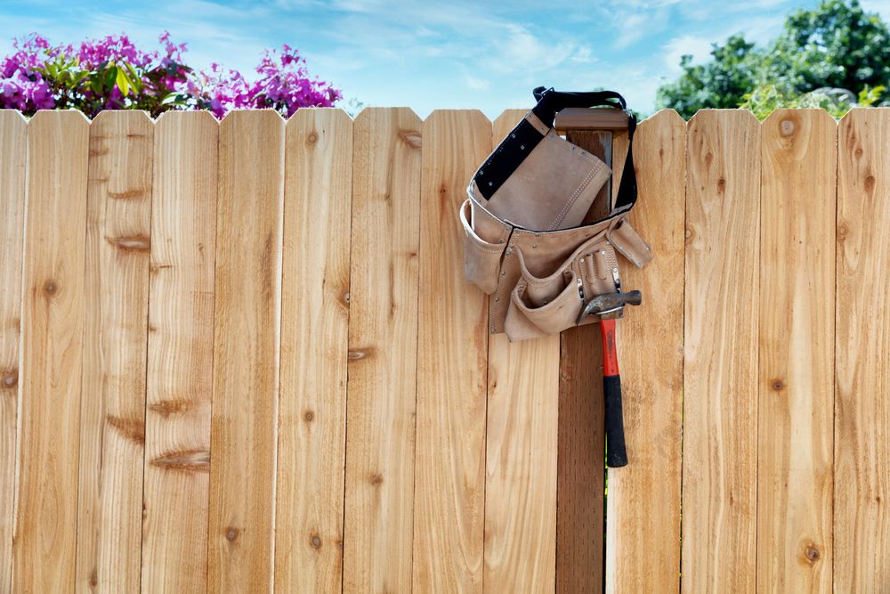 Tool belt with pouch hanging for new cedar wooden fence