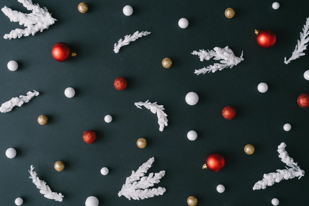 Christmas tree branches with red decorations on dark table background