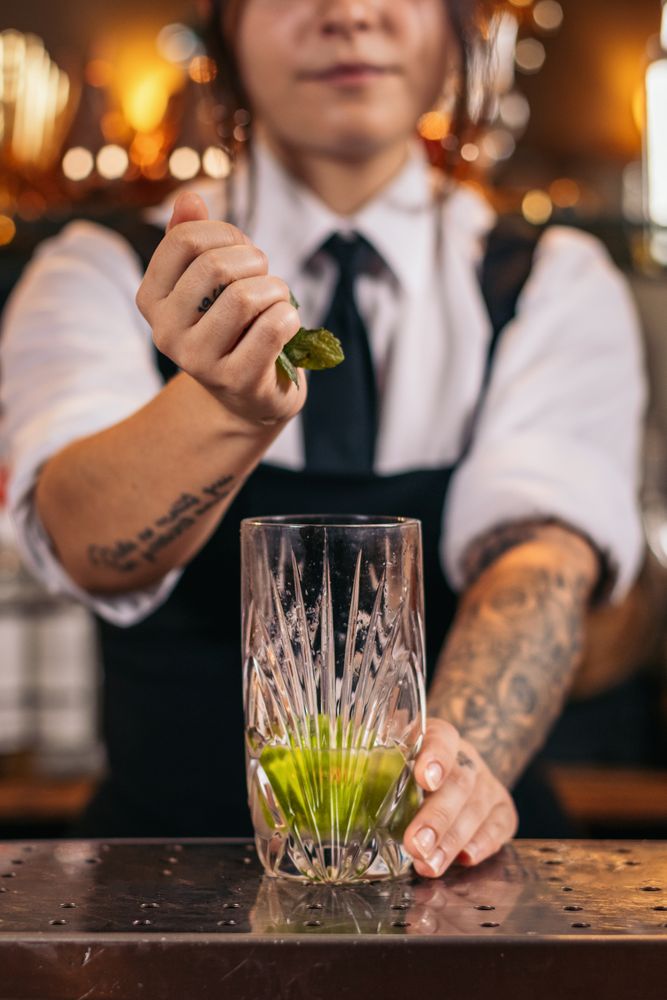 Bartender preparing a mojito in a cocktail bar
