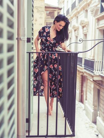 Stylish woman in dress on balcony