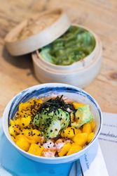 Appetizing poke dish in bowl on table