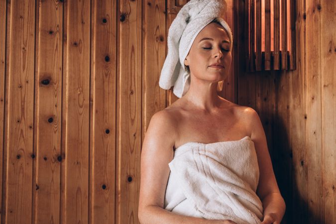 Woman sitting in a spa with eyes closed