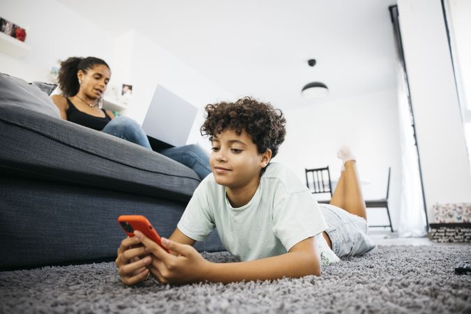 Mother and her daughter sitting on sofa