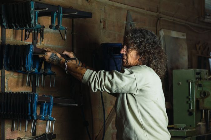 Man using carpentry tool in workshop