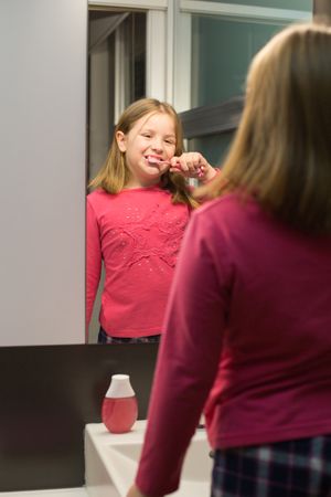 Cute girl brushing her teeth