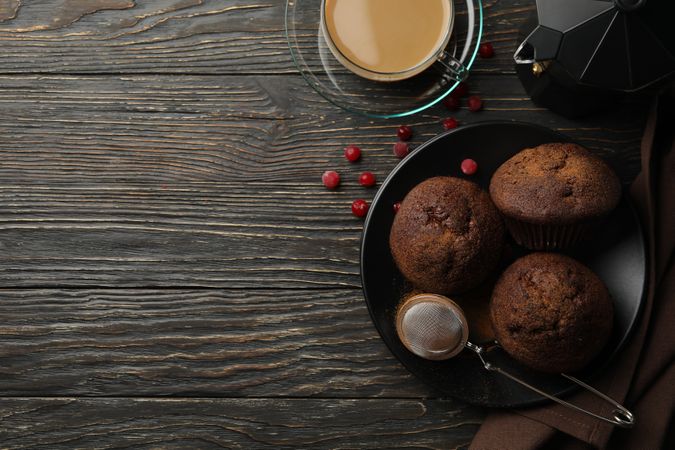 Composition with tasty muffins and cocoa drink on wooden background
