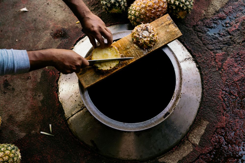Casual man cutting pineapple
