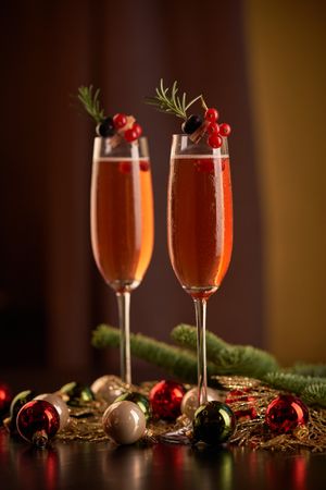 Glasses with champagne amidst Christmas baubles