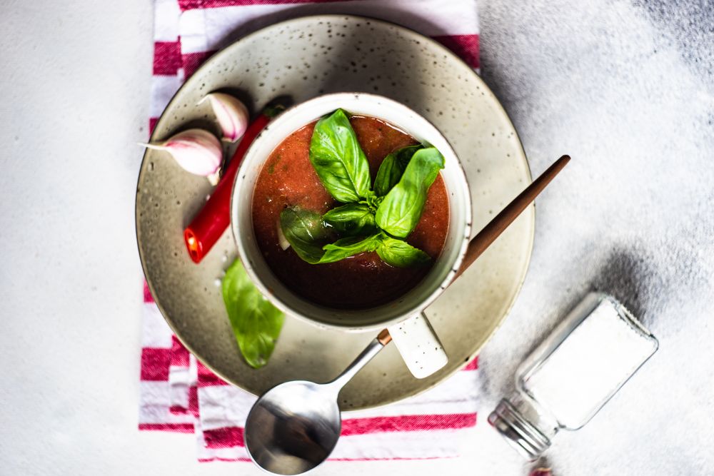 Top view of traditional gazpacho soup with basil, garlic and pepper