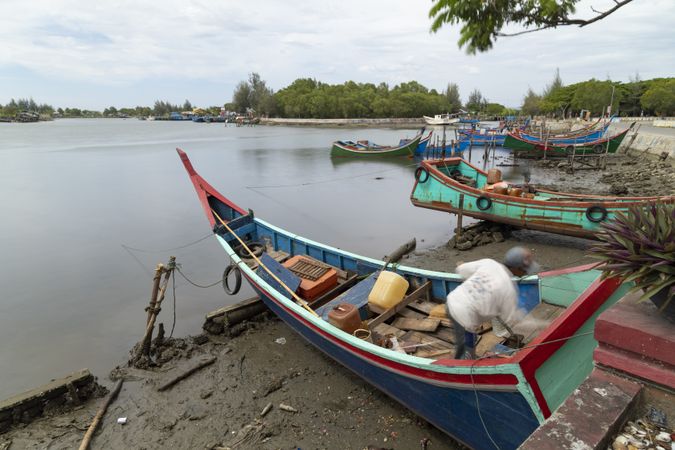 A fisherman prepares his traditional fishing boat on the outskirts of Banda Aceh, Sumatra, Indonesia