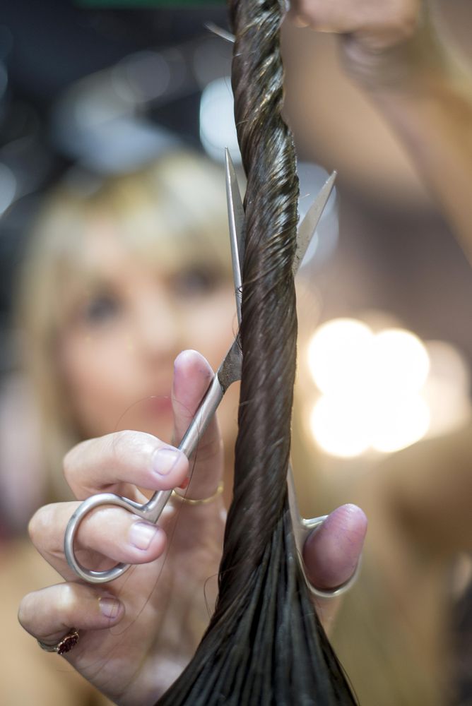 Close up twisted brunette wet hair to be cut