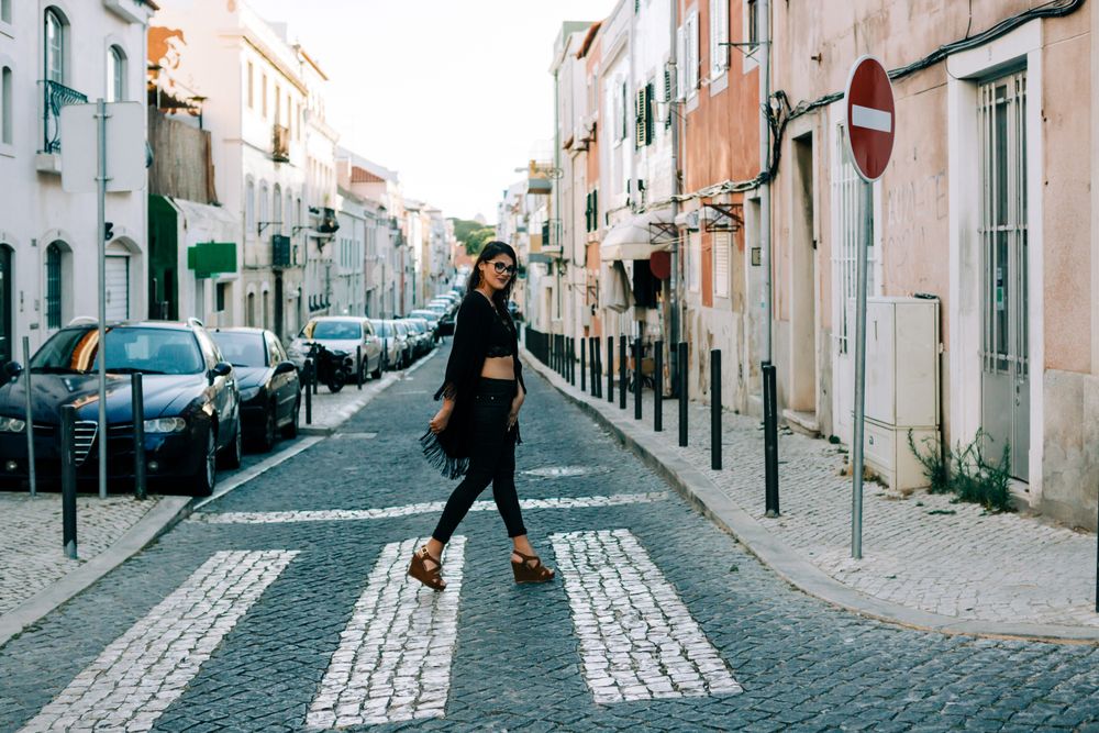 Joyful trendy female in old town street