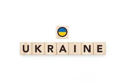 Wooden blocks bearing the name and flag of Ukraine. Ukrainian and East European Culture, national identity, travel, and geography in a copy space design.