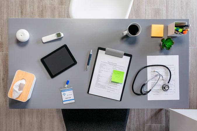 Doctor desk with documents and stethoscope