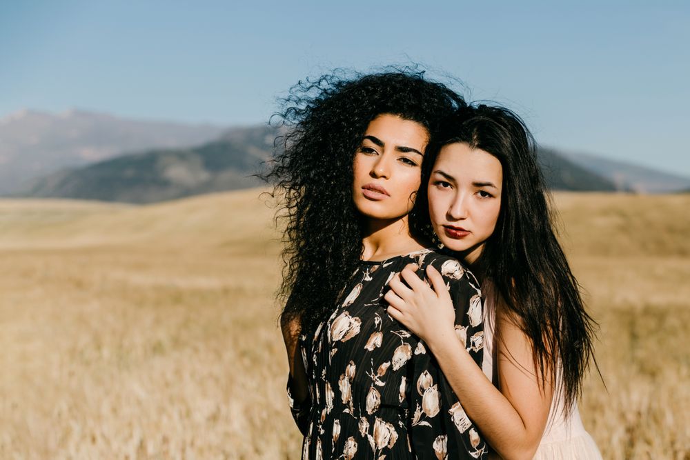 Female friends standing in field