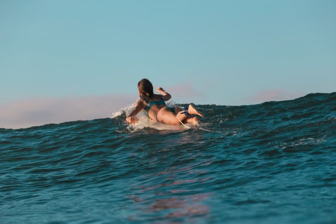 woman on surf board floating on water