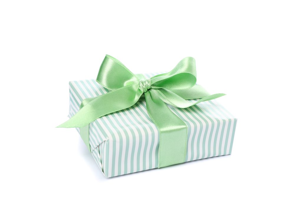 Gift box with green bow isolated on blank background