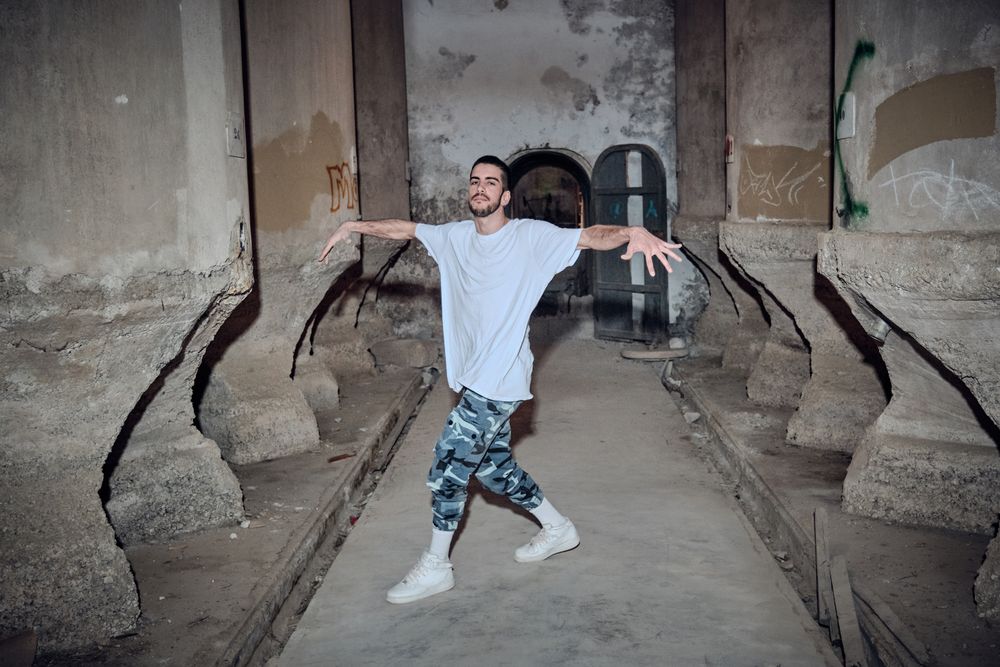 Confident man break dancing in desolated building