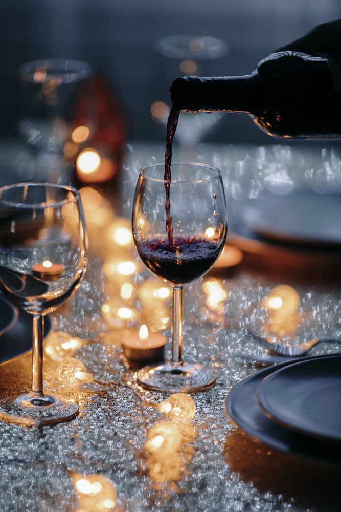 Close up of wine glass being filled at holiday setting