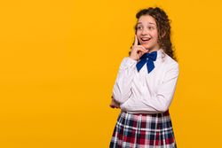 Girl smiling with finger to chin