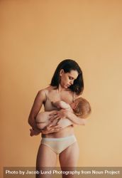 Postpartum mother breastfeeding her baby 413ep0