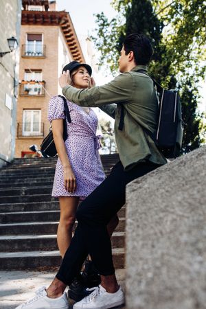 Happy couple having fun sitting in the street