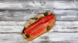 Rainbow trout fillet side skin down on olive board