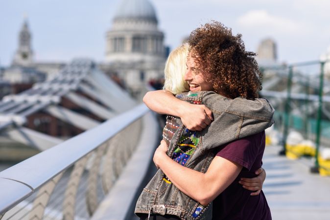 Man and woman hugging on bridge in London