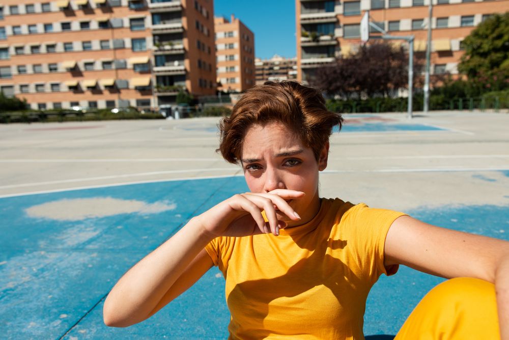 Trendy young woman on playground in sunny day