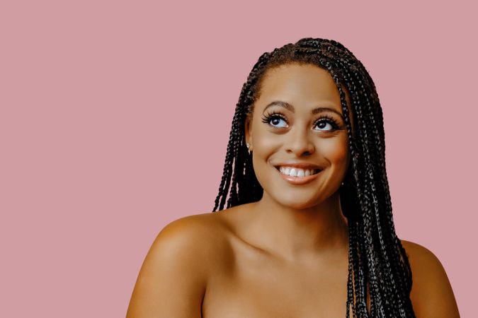 Studio portrait of smiling female with braided hair, copy space