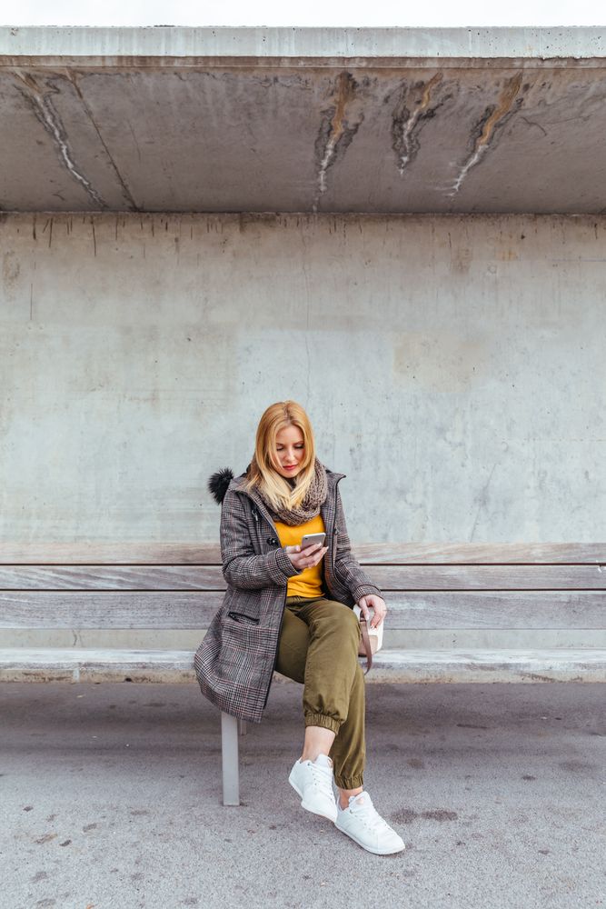 Portrait of blonde woman using her mobile phone