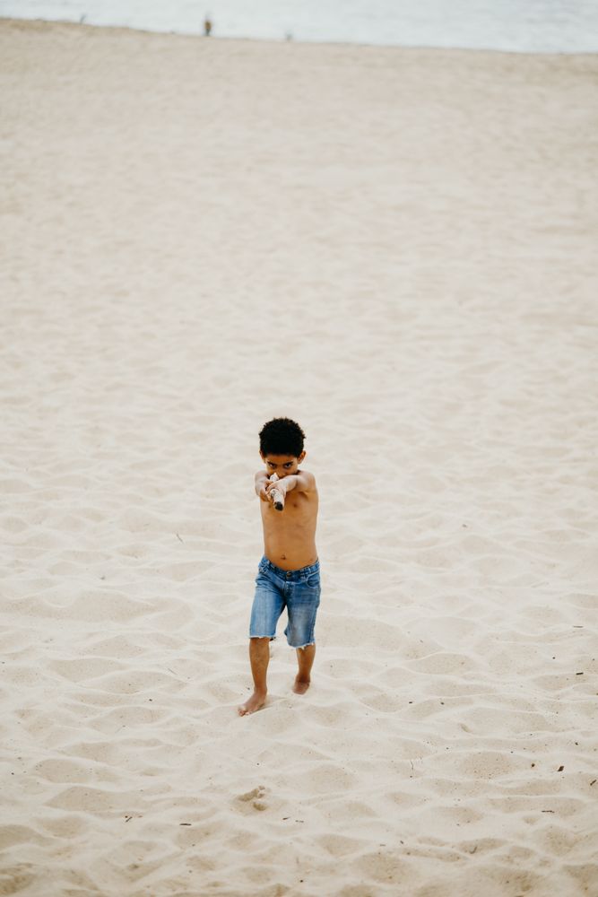Black boy playing on beach