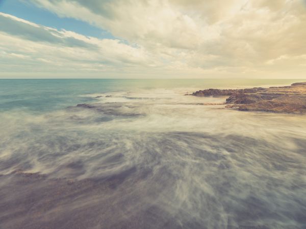 Rocky seashore under blue sky